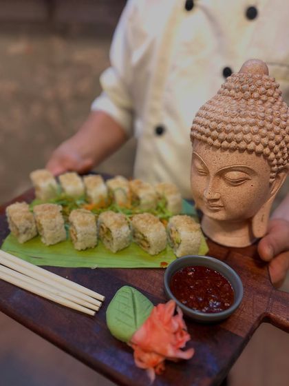Another angle of our beautiful sushi presentation. The combination of the rustic wooden board, fresh banana leaf, and artistic props makes our food a talking point at any event.
