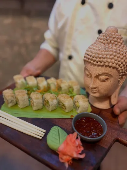 Another angle of our beautiful sushi presentation. The combination of the rustic wooden board, fresh banana leaf, and artistic props makes our food a talking point at any event.