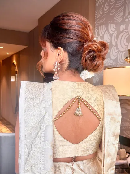 I love creating textured updos that look effortlessly romantic. For this look, I built volume at the crown and twisted the hair into a soft, low bun, leaving some strands loose to frame the face. It’s a sophisticated style that works beautifully for both brides and bridesmaids.