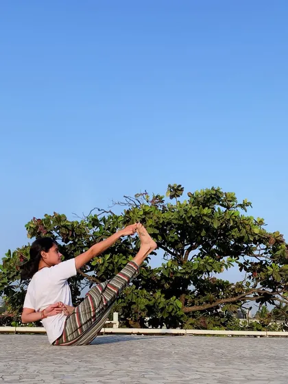 Being a yoga sadhak (practitioner) in the modern world means practicing detachment while living in attachment. This pose, a variation of Paripurna Navasana, requires core strength and focus, symbolizing the inner stability we cultivate.