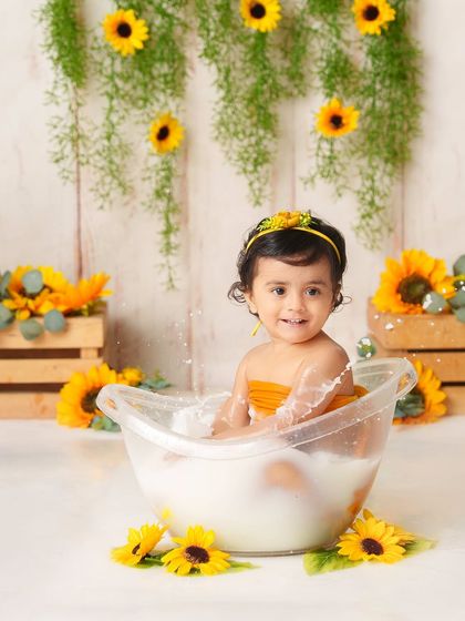 A happy splash in a sunflower-filled tub. This shot captures a perfect moment of action and laughter during one of my favorite themed sessions.