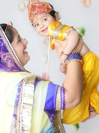 Lifting her little Krishna high! These joyful, interactive poses create such dynamic and emotional photographs.