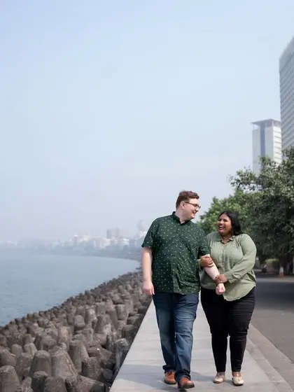A serene walk along Mumbai's Marine Drive, capturing the couple against the vastness of the sea and the city skyline.