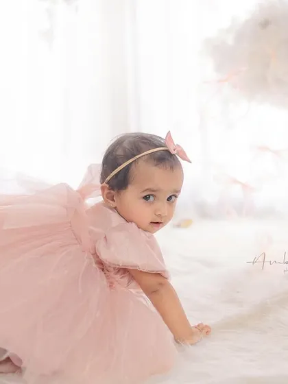 A candid moment of the birthday girl crawling away from her cake. These playful, unposed shots are often the most memorable.
