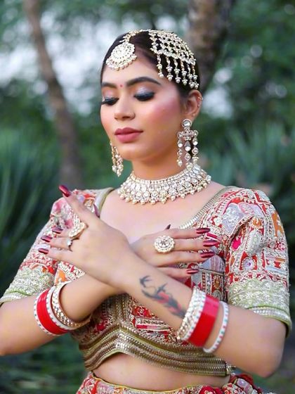 This shot showcases the complete bridal look with the paasa and heavy jewelry. The makeup is kept balanced with a focus on the eyes, while the skin remains flawless and radiant.