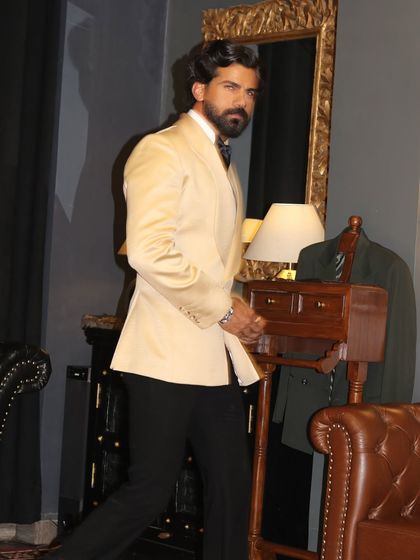 In motion, the ivory tuxedo maintains its structure and elegance.