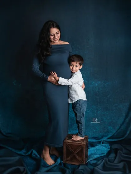 A sweet and tender moment between a boy and his mom. The way he hugs her baby bump shows how excited he is to become a big brother.