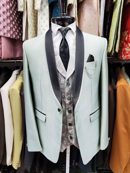 The complete sea green five piece tuxedo set. This is a sophisticated option for a groom looking for a unique color palette for his wedding day.