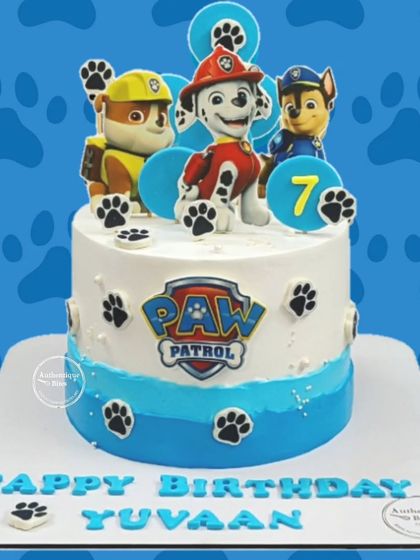 A fun Paw Patrol cake for a 7th birthday. This design features Marshall, Rubble, and Chase ready for action, with paw prints decorating the sides.