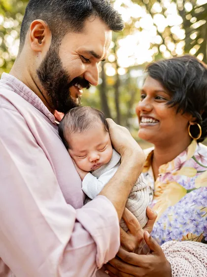 The pure joy and laughter between new parents as they admire their sleeping baby. My lifestyle approach focuses on capturing these candid, emotional moments that truly define your family's story.