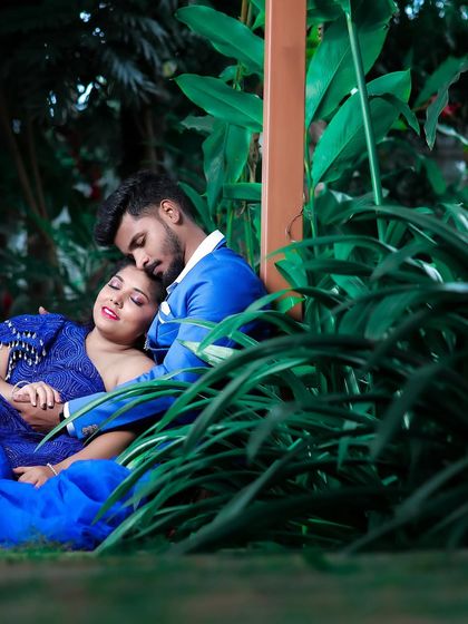Another beautiful shot from the pre-wedding shoot. This time, they are in coordinated shades of blue, looking serene and romantic in a lush green setting.