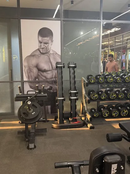 A look inside The Fitness Bar, showing the spacious layout and wide range of dumbbells and workout stations.