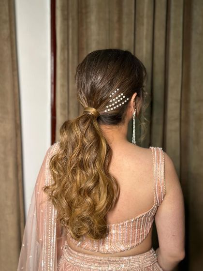A clear view of the pearl slide accessory in this chic ponytail.