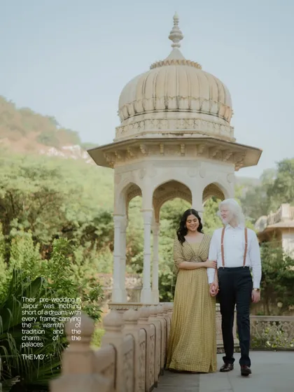 A gentle stroll through the gardens of a Jaipur palace. This candid pre-wedding photo captures a natural, relaxed moment between the couple, with the historic cenotaph adding a touch of timeless elegance.