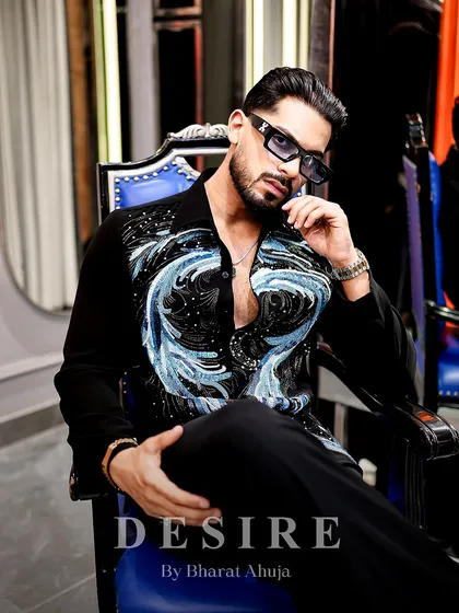 Modern luxury with an artistic soul. This black shirt features a dynamic wave of blue embroidery, a design I created for the man who appreciates wearable art. It is a piece that is both a conversation starter and a testament to individual style.