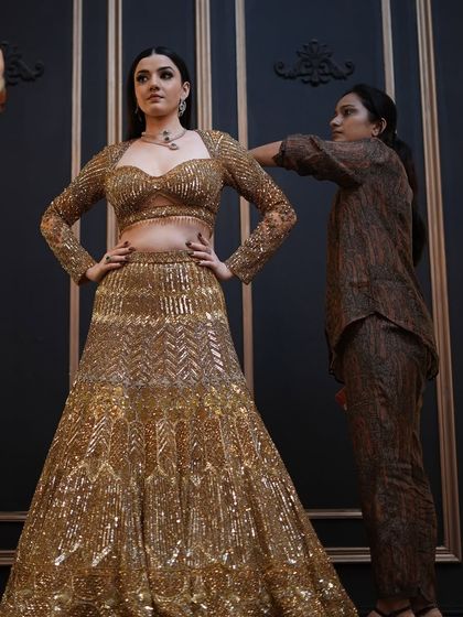 A behind-the-scenes moment from the shoot. You can see me making final adjustments to ensure every detail is perfect for the camera.