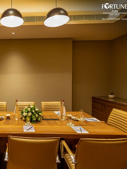 The corner view of my boardroom reveals its quiet elegance and professional setup. Fresh flowers and readily available water are just a few of the touches I add to make your meeting experience exceptional.