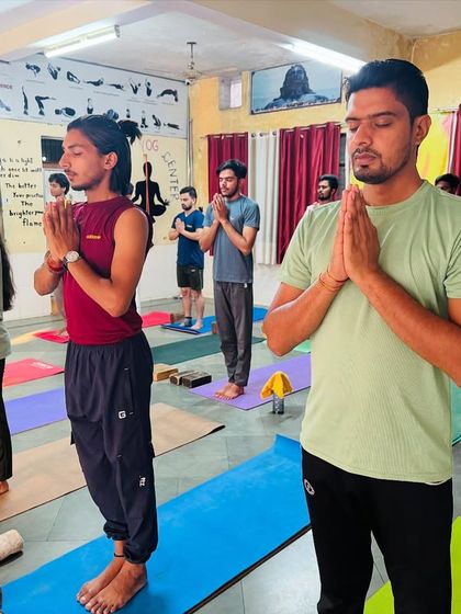 A full view of my class standing in prayer. This moment of collective intention sets the tone for our practice.