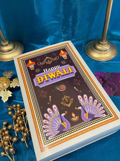 The beautifully designed lid for our festive Diwali box, featuring peacock illustrations. This artwork adds a traditional and artistic touch to your gift.