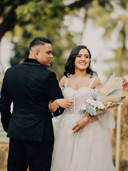 A candid walking shot of the couple sharing a look. The focus is on their natural interaction and the joy of the moment.