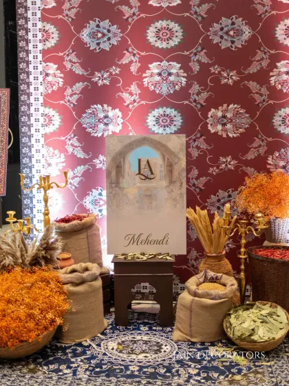This Mehndi corner is where royal heritage meets rustic charm. I used traditional textiles, earthy elements like jute bags filled with spices, and a custom monogram to create a space that felt both grand and deeply personal.