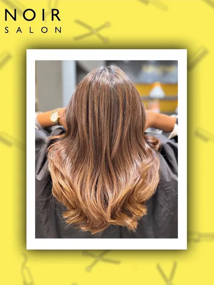 A beautiful example of a warm-toned balayage. The color melts from a natural root into lighter, caramel ends, creating a seamless and sun-kissed look.
