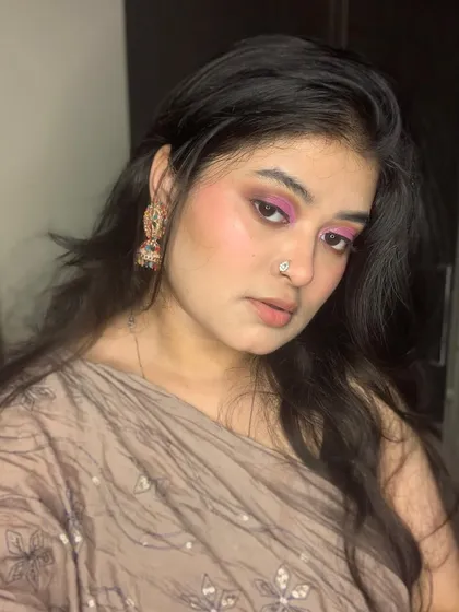 A beautiful party look with shimmery pink eyeshadow and a traditional nose ring.
