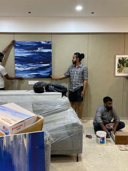 The moment of truth: hanging the artwork. Our team is on-site to ensure every piece is perfectly placed to complete the design narrative, as seen here during the setup of 'Vishu Home'.