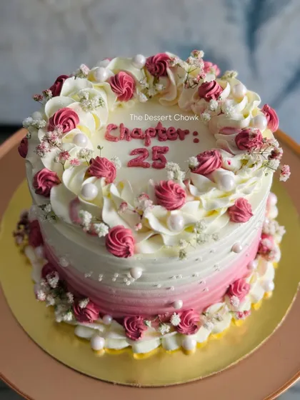 A closer look at the "Chapter 25" cake, showing the detailed piping work.