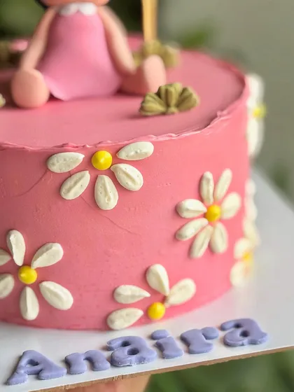 Halfway to one, twice the fun! A close-up of the daisy details on this sweet six-month celebration cake.