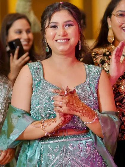 A happy moment. Her radiant makeup and beautiful smile light up the photo.