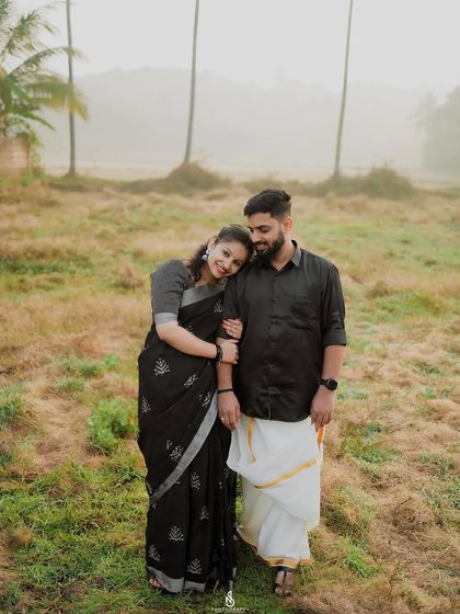 A sweet and simple portrait, with her resting her head on his shoulder. This pose conveys comfort and love.