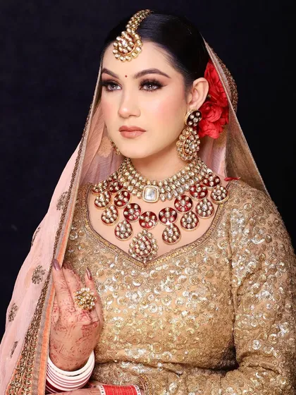 Graceful as a Jogan. A simple red flower can be a powerful hair accessory, adding a pop of color and romance to this golden look.
