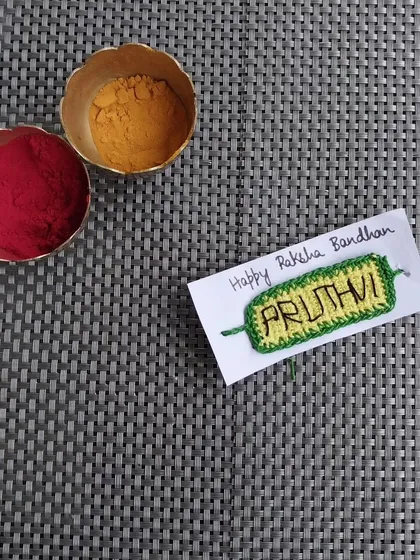 A custom name rakhi I made for Raksha Bandhan. I can crochet any name onto the rakhi for a personalized touch.