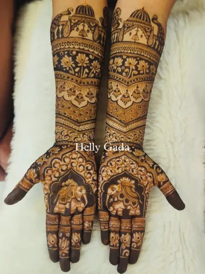 The full view of the intricate bridal design, with majestic elephants on the palms and a symphony of traditional motifs on the arms.