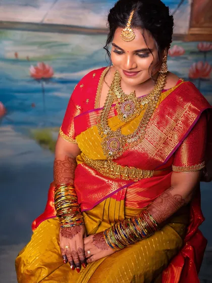 The details tell the story. This close-up highlights the beauty of the seemantham ceremony, from the stacks of colorful bangles and intricate temple jewelry to the rich texture of the saree. I ensure every element that makes your day special is beautifully preserved.