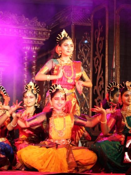 The full ensemble of dancers in a grand formation for the "Nava Durga" production. The variety of colors in their costumes represents the different forms of the Goddess.
