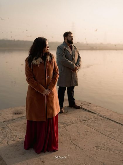 A serene portrait by the water's edge, capturing a moment of quiet reflection and togetherness.