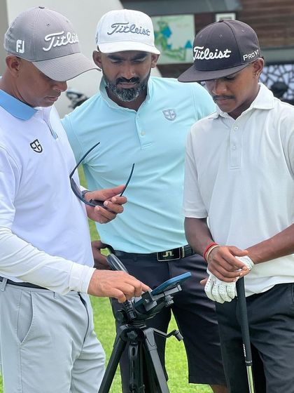 Technology is integrated directly into our on-field coaching. Here, my coaches and I review video analysis with a player on a tablet, providing immediate feedback during a practice session.