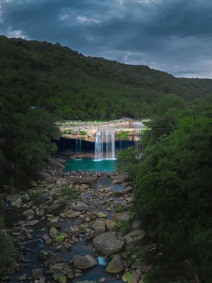 The stunning turquoise waters of Krang Suri falls in Meghalaya, a popular spot for locals and travelers to cool off.