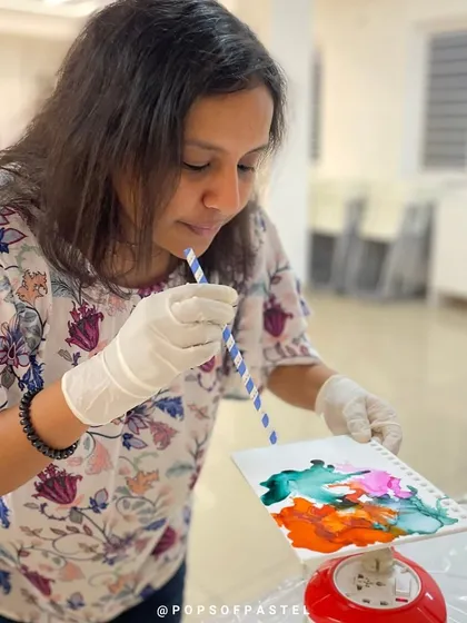 Blowing through a straw to guide the flow of alcohol ink is a simple yet effective way to create beautiful patterns.