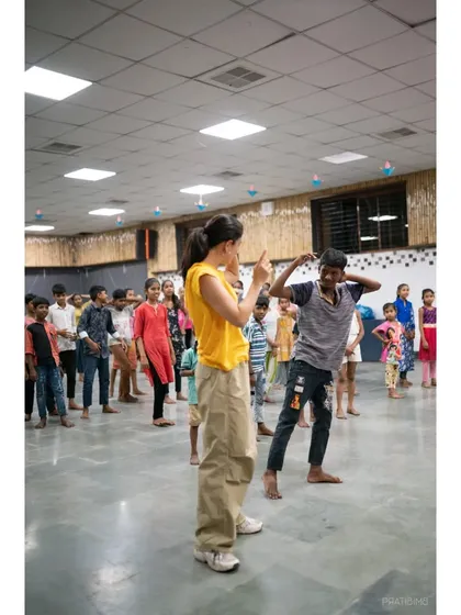 One on one instruction with a talented young dancer. This photo highlights a moment of teaching and encouragement during our International Dance Day event.