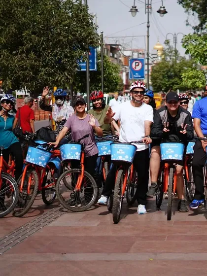 Waving and smiling, our riders are fully engaged in the adventure of exploring Chandni Chowk.