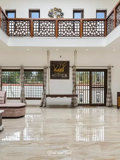 Another view of the spacious living room, showing a large gallery wall of family photos. This personal touch makes the grand space feel warm and full of memories.