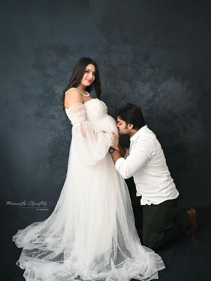 A classic pose of devotion. The dad-to-be kneels to kiss the baby bump, a timeless and emotional gesture that I love to capture.