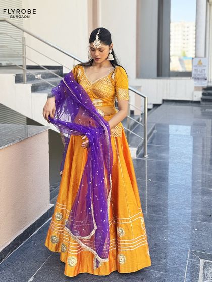 A full shot of the yellow and purple lehenga, showing how beautifully it flows. It's a fantastic rental option for influencers or for a Haldi or Sangeet event.