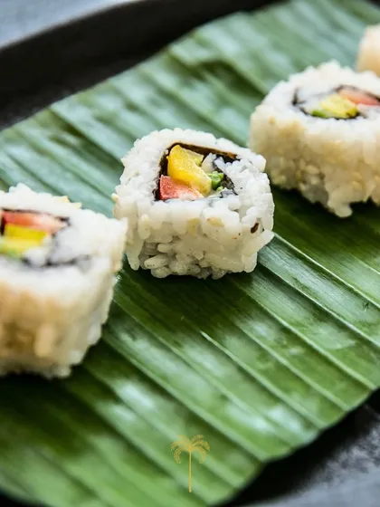 Simple yet elegant vegetable maki rolls presented on a fresh banana leaf. This highlights our commitment to using fresh ingredients and clean, beautiful presentation.