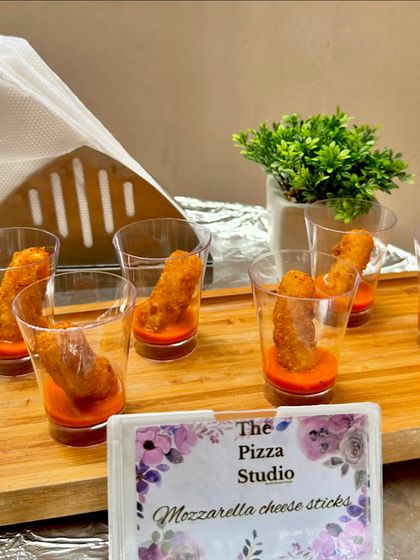 Golden-fried mozzarella cheese sticks served in individual glasses with a marinara sauce. This is a classic comfort food appetizer that we elevate with a clean and convenient presentation.