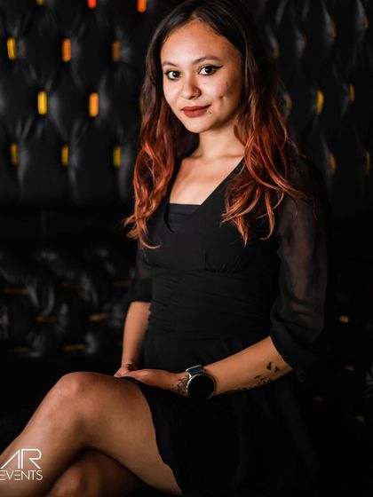 A guest sitting in a tufted leather booth.