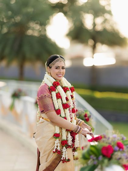 An outdoor shot of the Iyengar bride, where the natural light beautifully highlights her glowing skin and the details of her attire.